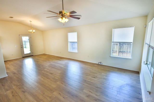 2608 Salamanca St, Navarre, FL 32566 - unfurnished room with a chandelier, a ceiling fan, hardwood / wood-style flooring, lofted ceiling, and baseboards
