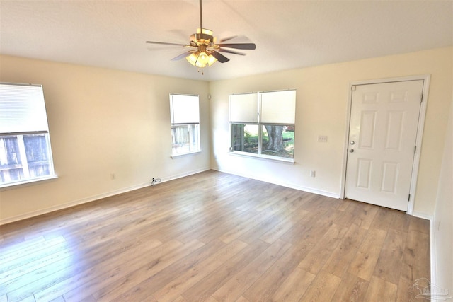 2608 Salamanca St, Navarre, FL 32566 - unfurnished room featuring wood finished floors, a ceiling fan, and baseboards
