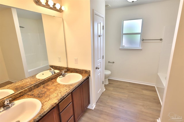 2608 Salamanca St, Navarre, FL 32566 - bathroom with toilet, double vanity, wood finished floors, and shower / tub combination