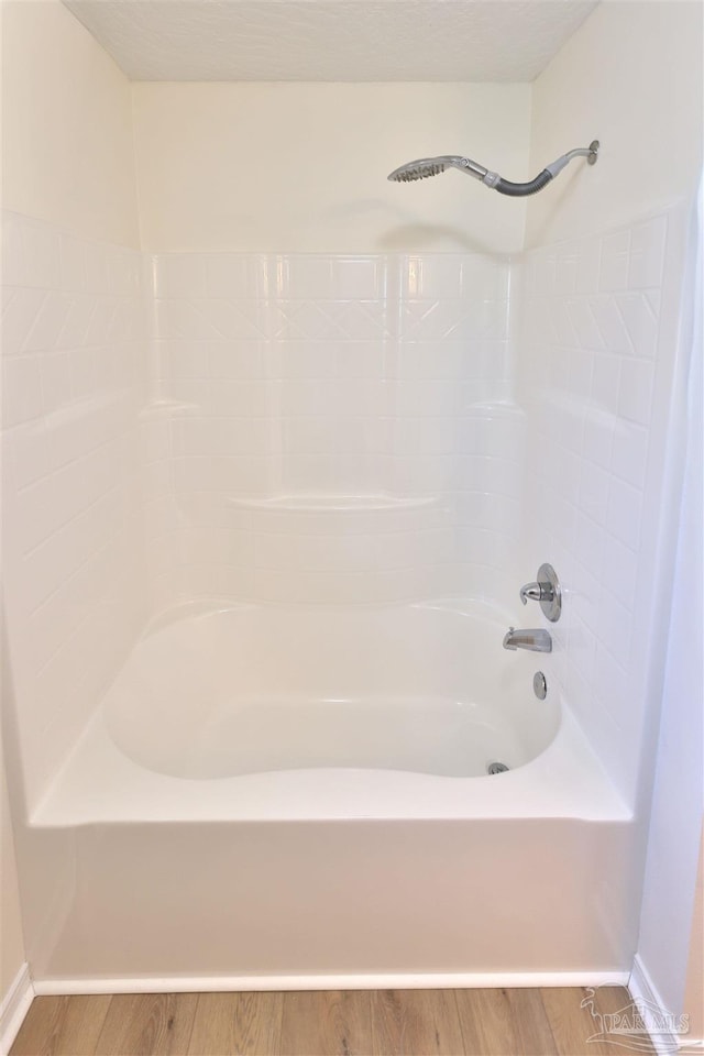 2608 Salamanca St, Navarre, FL 32566 - bathroom with wood finished floors, baseboards, and washtub / shower combination