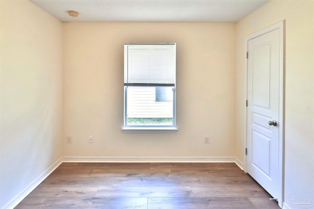 2608 Salamanca St, Navarre, FL 32566 - empty room with wood finished floors, a smoke detector, and baseboards