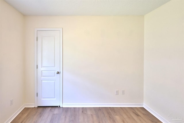 2608 Salamanca St, Navarre, FL 32566 - empty room with wood finished floors and baseboards