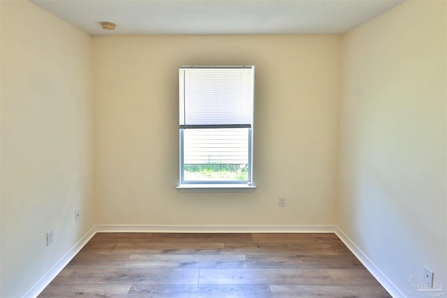 2608 Salamanca St, Navarre, FL 32566 - empty room featuring wood finished floors, a smoke detector, and baseboards