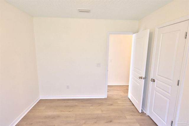 2608 Salamanca St, Navarre, FL 32566 - unfurnished bedroom featuring light wood-type flooring and baseboards