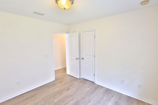 2608 Salamanca St, Navarre, FL 32566 - unfurnished bedroom featuring light wood-style flooring and baseboards