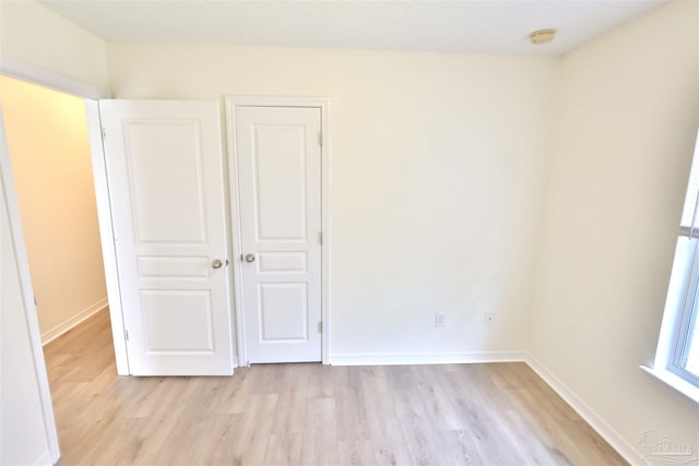 2608 Salamanca St, Navarre, FL 32566 - unfurnished bedroom featuring light wood-style flooring and baseboards