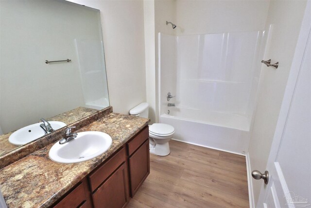 2608 Salamanca St, Navarre, FL 32566 - full bathroom with wood finished floors, vanity,  shower combination, and toilet