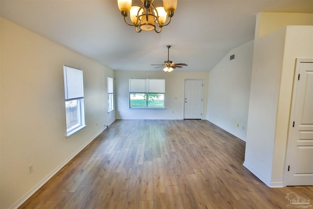 2608 Salamanca St, Navarre, FL 32566 - unfurnished living room with a chandelier, wood finished floors, baseboards, lofted ceiling, and a ceiling fan