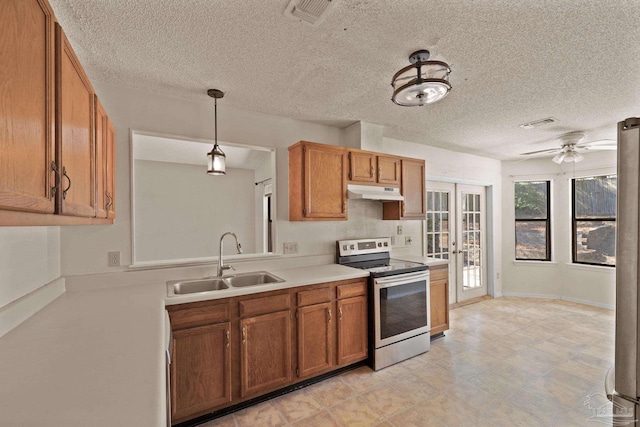 kitchen with stainless steel electric stove, pendant lighting, french doors, sink, and ceiling fan