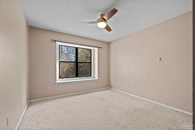 spare room with a textured ceiling, carpet floors, and ceiling fan