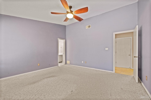 unfurnished bedroom featuring ceiling fan and carpet