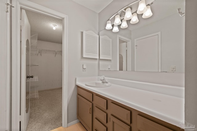 bathroom with a textured ceiling and vanity