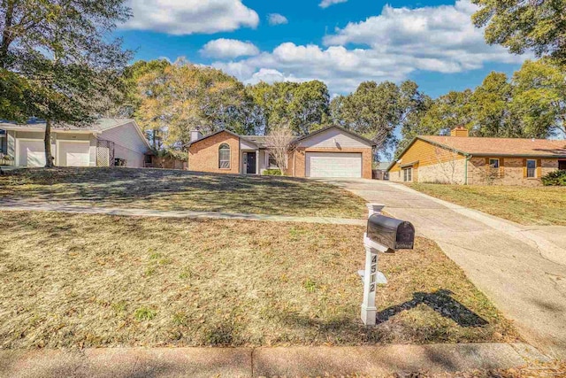 ranch-style house featuring a garage and a front yard