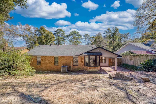 rear view of house with central AC unit and a patio area