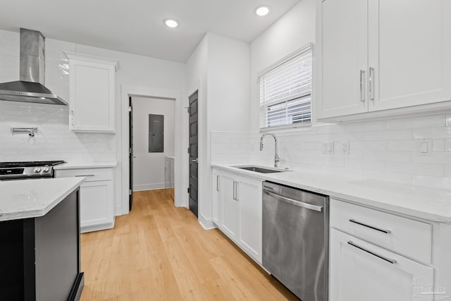 kitchen with sink, white cabinetry, stainless steel appliances, light stone countertops, and wall chimney exhaust hood