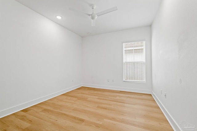 spare room with wood-type flooring and ceiling fan