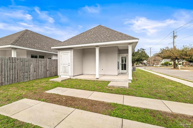 back of property featuring central AC, a porch, and a lawn