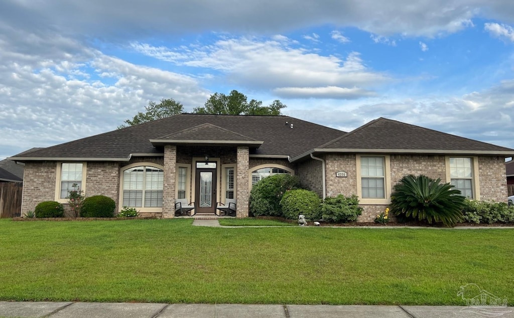 4356 Winners Gait Cir, Pace, FL 32571 - view of front facade with a front lawn, brick siding, and a shingled roof