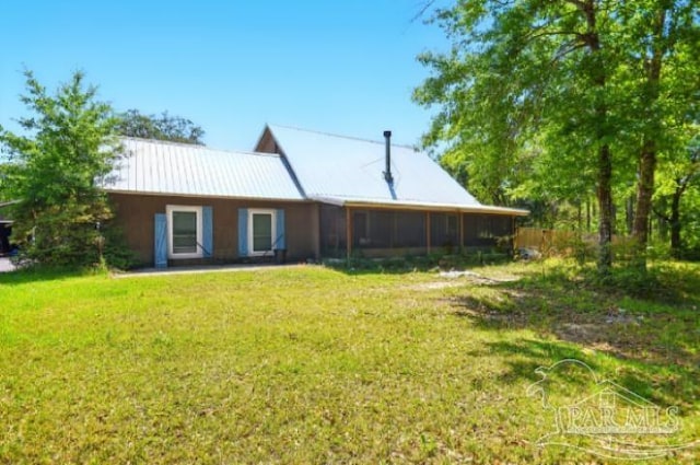 2738 Garcon Point Rd, Milton, FL 32583 - rear view of house with a yard, metal roof, and a sunroom