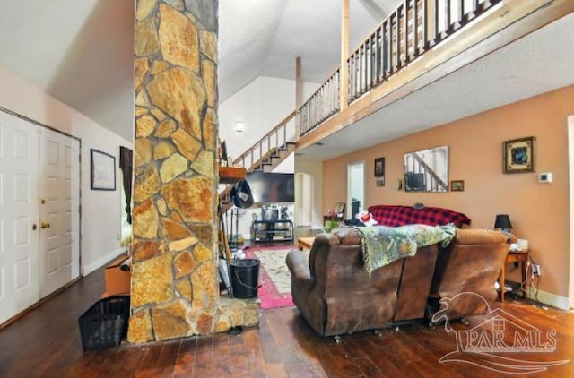 2738 Garcon Point Rd, Milton, FL 32583 - living room with high vaulted ceiling, wood-type flooring, baseboards, and stairs