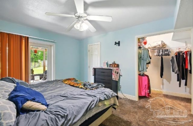 2738 Garcon Point Rd, Milton, FL 32583 - bedroom with a spacious closet, carpet flooring, a closet, baseboards, and a ceiling fan