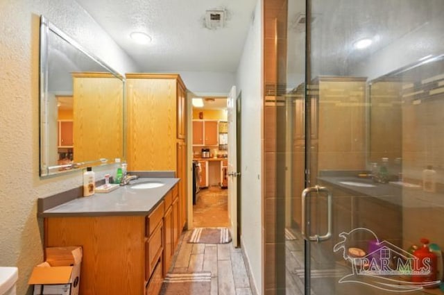 2738 Garcon Point Rd, Milton, FL 32583 - full bath featuring vanity, a textured wall, a stall shower, and toilet
