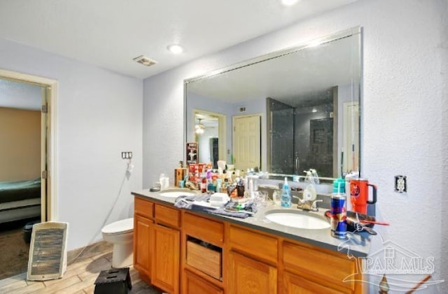 2738 Garcon Point Rd, Milton, FL 32583 - bathroom with double vanity, wood finished floors, toilet, and a shower