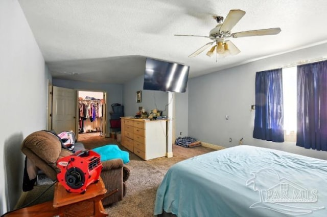 2738 Garcon Point Rd, Milton, FL 32583 - bedroom featuring carpet, a walk in closet, ceiling fan, and a closet