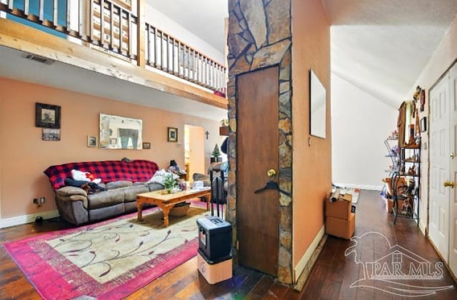 2738 Garcon Point Rd, Milton, FL 32583 - living room featuring wood-type flooring, baseboards, and vaulted ceiling