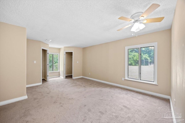 3950 Oakus Dr, Milton, FL 32583 - carpeted spare room featuring healthy amount of natural light, baseboards, a ceiling fan, and a textured ceiling