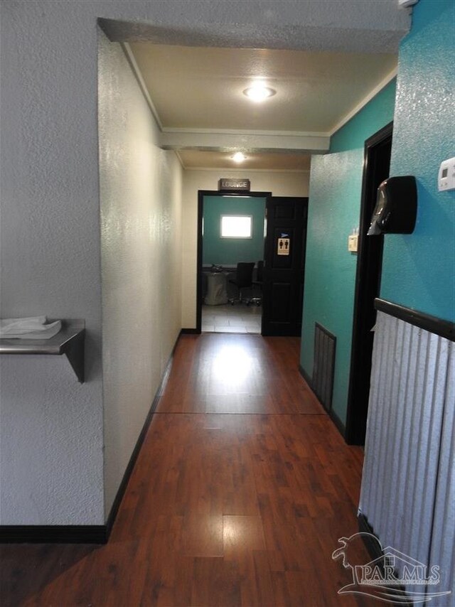 hall featuring wood-type flooring and ornamental molding