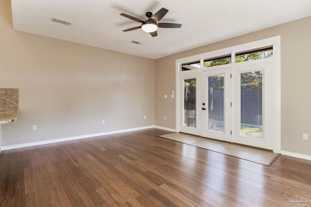 unfurnished room featuring visible vents, baseboards, and wood finished floors