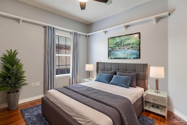 bedroom with ceiling fan, wood finished floors, and baseboards