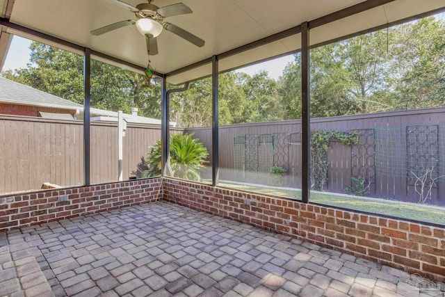 unfurnished sunroom with a healthy amount of sunlight and a ceiling fan