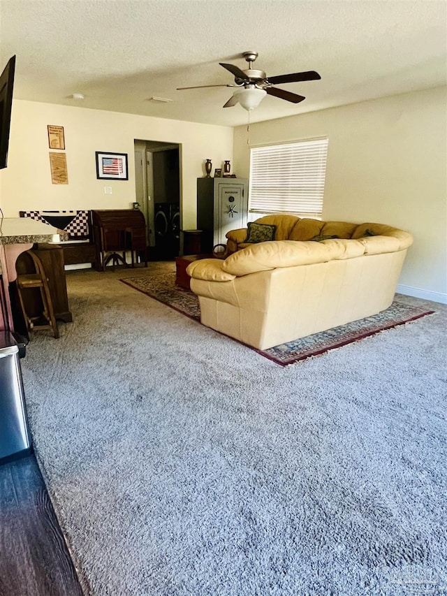 unfurnished living room featuring ceiling fan and a textured ceiling