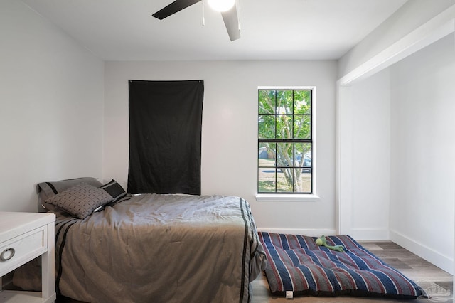 bedroom with ceiling fan and light hardwood / wood-style floors