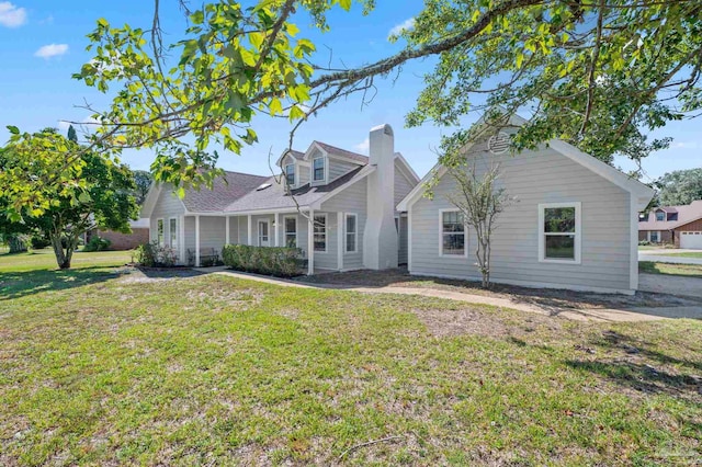 cape cod house featuring a front yard