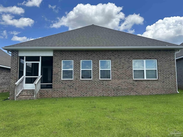7581 Burnside Loop, Pensacola, FL 32526 - rear view of house featuring brick siding, a shingled roof, and a lawn
