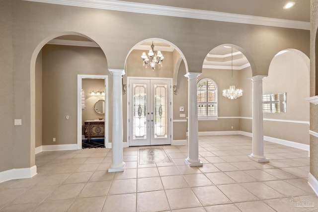 foyer featuring french doors, arched walkways, light tile patterned floors, a chandelier, and ornamental molding