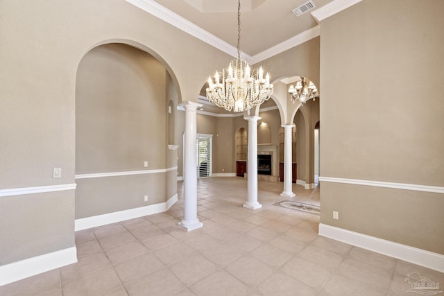 unfurnished dining area with arched walkways, crown molding, light tile patterned flooring, a chandelier, and a tile fireplace
