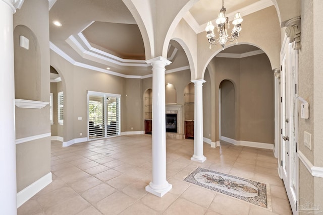 entrance foyer featuring a fireplace, light tile patterned floors, crown molding, a chandelier, and recessed lighting