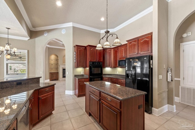 kitchen with black appliances, a chandelier, arched walkways, light tile patterned floors, and decorative light fixtures