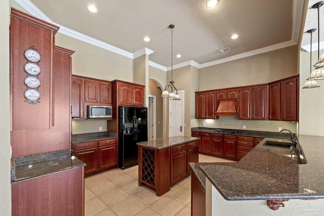 kitchen with stainless steel microwave, black fridge with ice dispenser, a sink, light tile patterned floors, and custom range hood