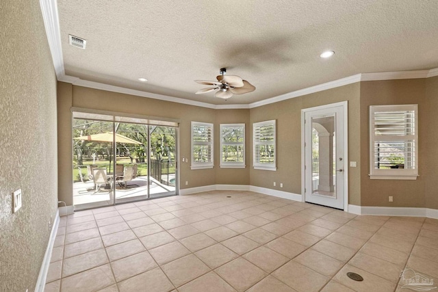 unfurnished room featuring a ceiling fan, light tile patterned floors, healthy amount of natural light, a textured ceiling, and crown molding