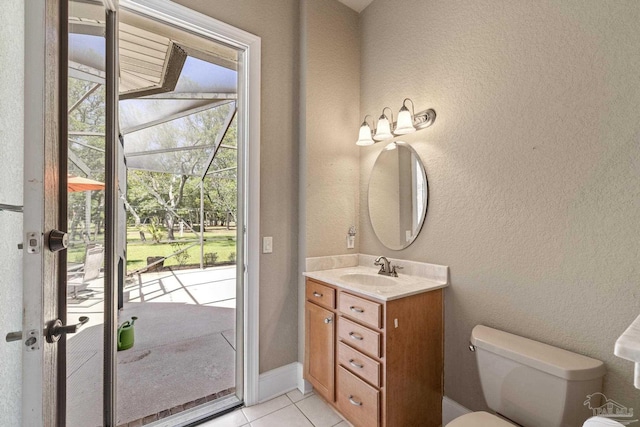 half bathroom with tile patterned floors, a textured wall, toilet, and vanity