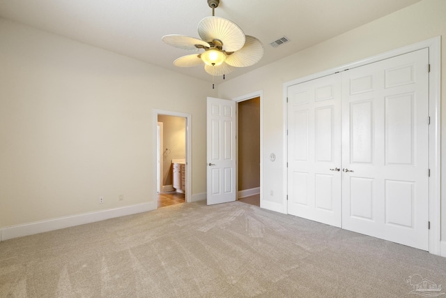 unfurnished bedroom featuring carpet, a closet, baseboards, and ceiling fan