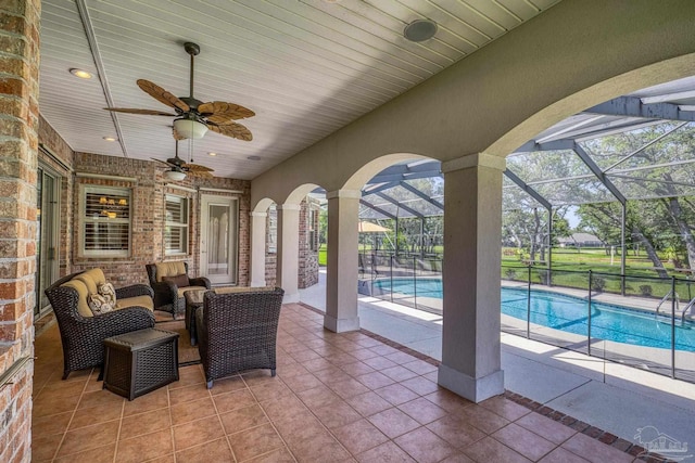view of patio featuring an outdoor pool, ceiling fan, an outdoor living space, and a lanai