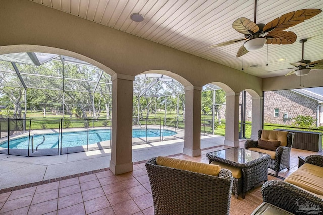 view of patio with outdoor lounge area, ceiling fan, an outdoor pool, and a lanai