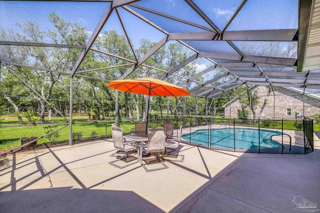 swimming pool with a patio area, a lanai, view of scattered trees, and a lawn