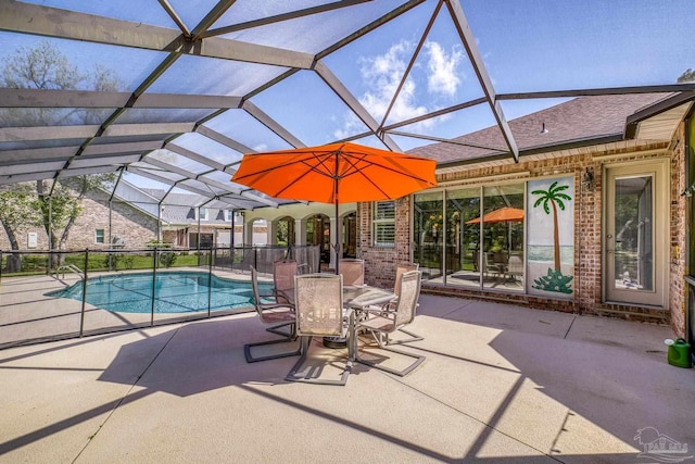 view of swimming pool with a patio and glass enclosure